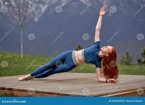 Skinny Beautiful Redhead Yoga Woman In Leggings And Sport Top Is Practicing Yoga Exercises Stock
