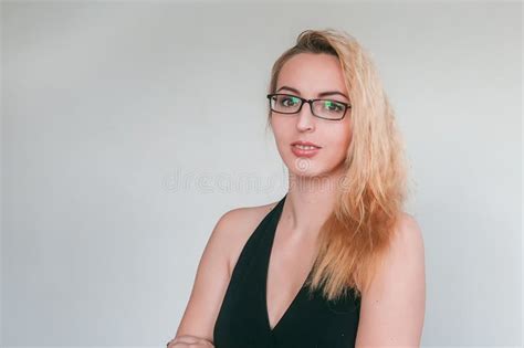 A Stylish Young Girl In Glasses And In A Black Dress With An Open