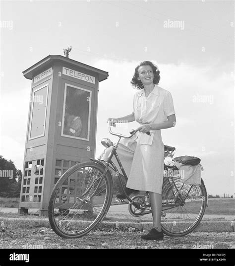 1940s Woman On A Bicycle A Smiling Young Woman On A Womens Bicycle Beside A Phone Booth Notice