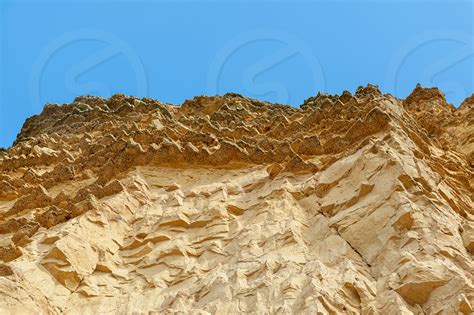 The Imposing And Eroded Sandstone Cliffs Exposing Millions Of Years Of
