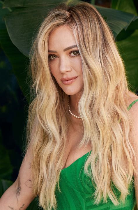 A Woman With Long Blonde Hair Wearing A Green Dress
