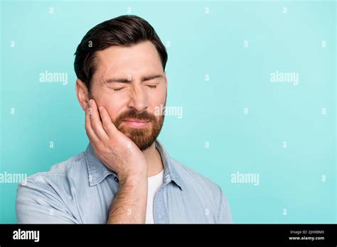 Portrait of frustrated guy touch hand cheek have severe tooth ache