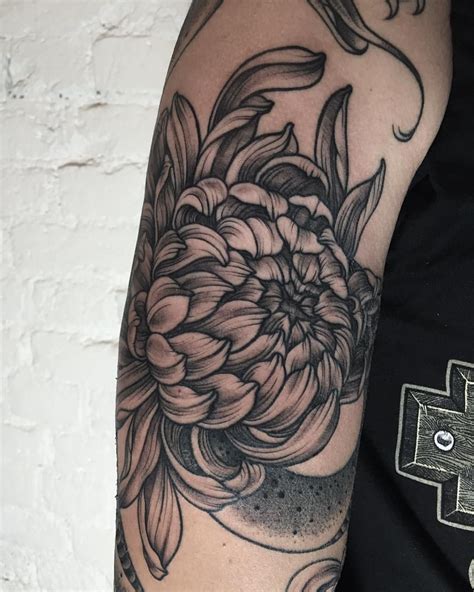 A Black And White Photo Of A Flower On Someones Arm With The Words