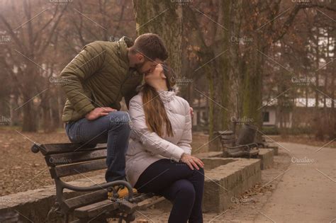 Young Couple Sitting Park Bench Kiss High Quality People Images ~ Creative Market