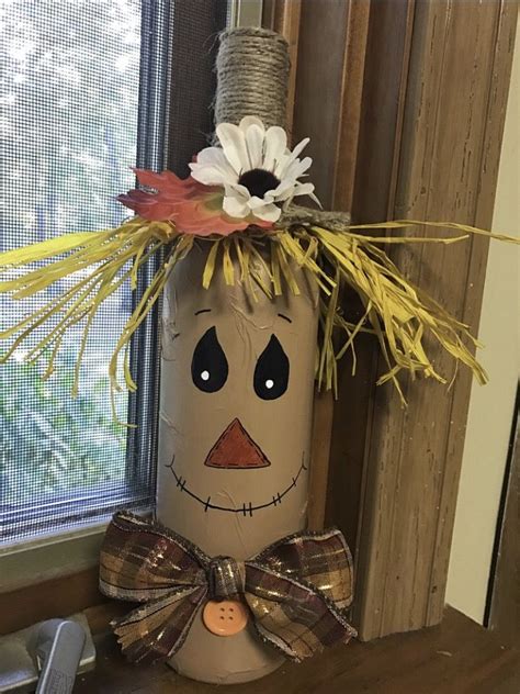 A Scarecrow Decoration Made Out Of Toilet Paper Rolls With Flowers On
