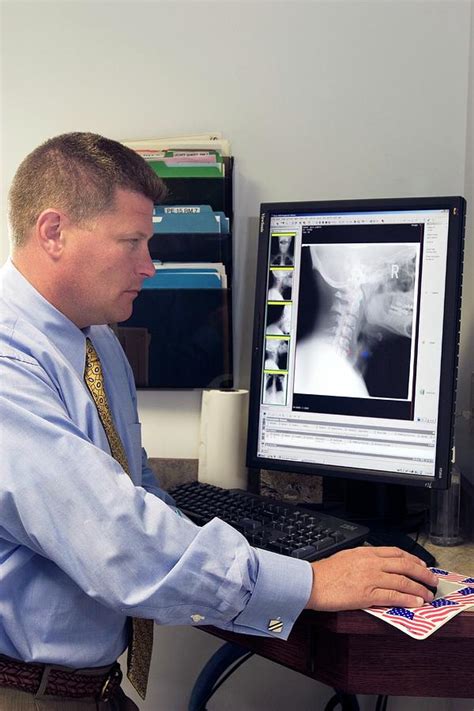 Chiropractor Examining Neck X Ray Photograph By Jim West