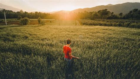 Man Standing In The Middle Of The Grass Field Picture Image