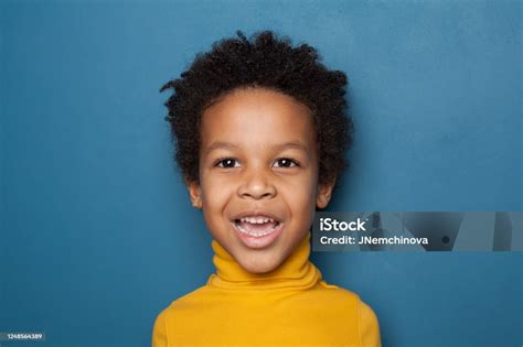 Surprised Black Kid Boy On Blue Background Stock Photo Download Image