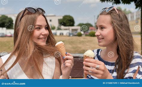 Two Girls Friends Eating Ice Cream On The Street Of The City Stock Image Image Of Background