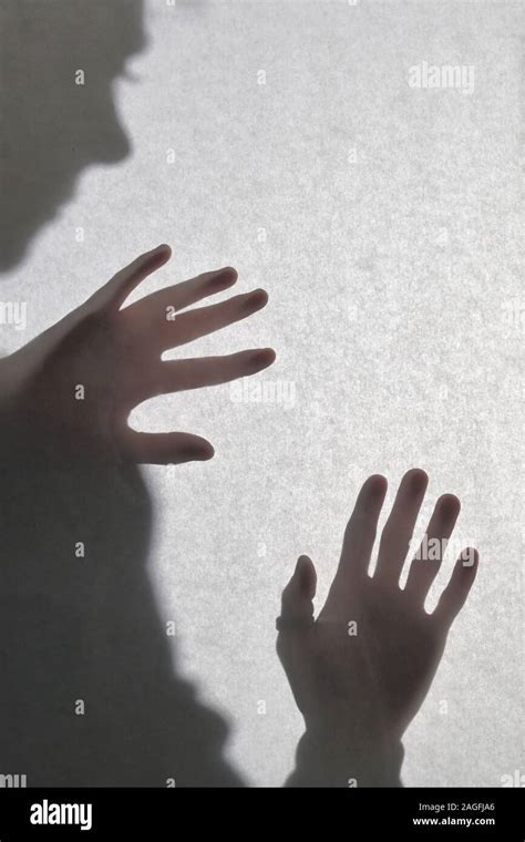 Shadowy Human Figure Behind A Matte Glass Stock Photo Alamy