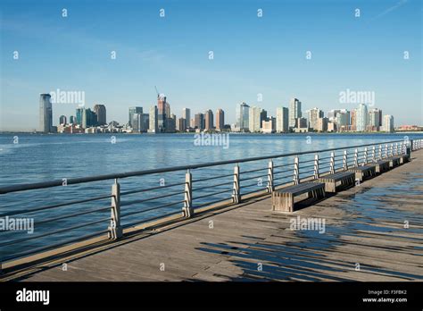 City Skyline Of Jersey City And Hoboken New Jersey From A Pier In New