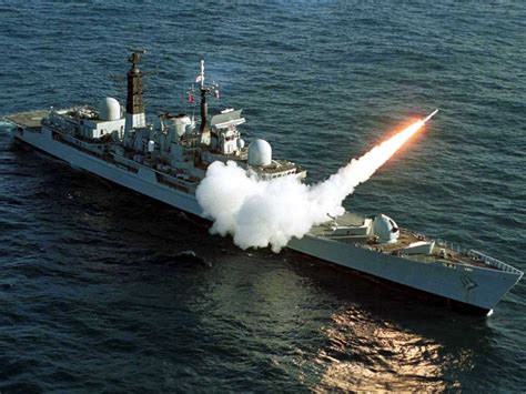 A Large Battleship With A Missile In The Water