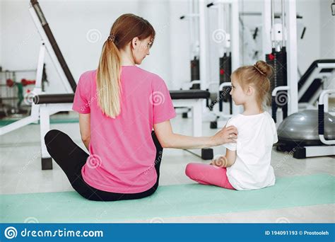 mother with little daughter are engaged in gymnastics in the gym stock image image of