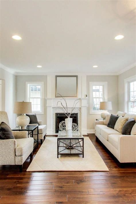 Cozy Living Room With A Gas Fireplace White Mantel And Marble Surround