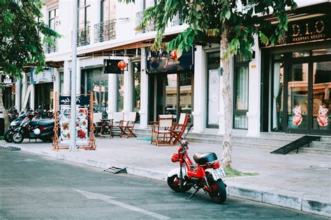 Red Motorcycle Parked Outside Storefront · Free Stock Photo