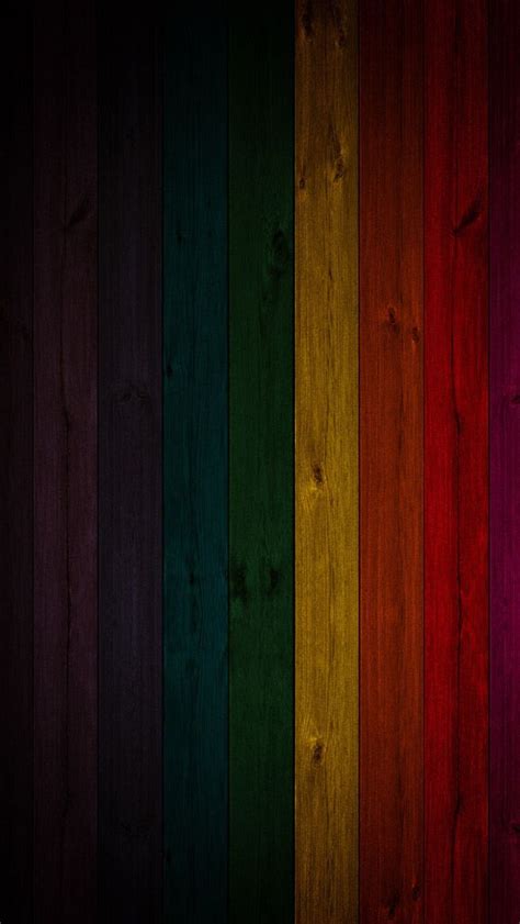 A Rainbow Colored Wallpaper With Wood Planks