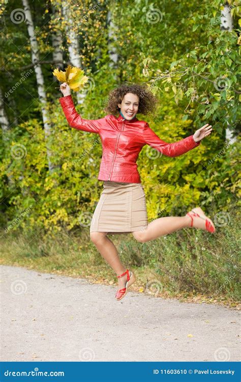 Happy Woman With Leaves In Jump In Wood In Autumn Stock Photo Image