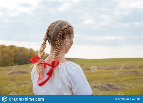 Russian Girl Slavic Appearance With Braids With Red Ribbons In The