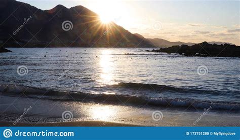 Beautiful Sunset On The Sea With Splashing Waves Sunlight Is Reflected