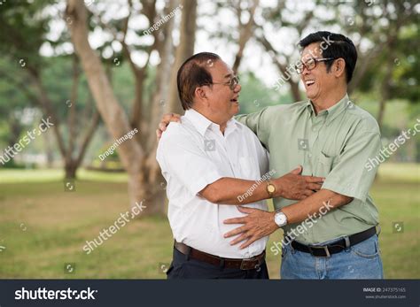 Aged Male Friends Greeting Each Other With A Hug Stock