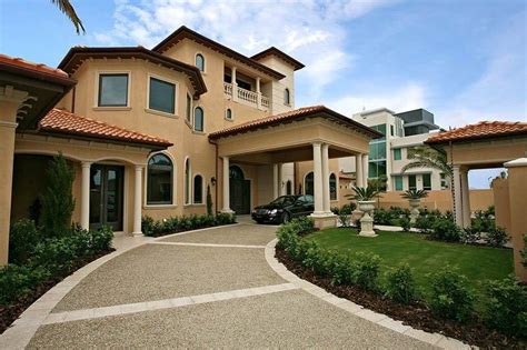 A Large House With Lots Of Windows And Landscaping
