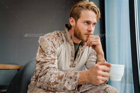 Masculine Confident Military Man In Uniform Sitting And Drinking Coffee