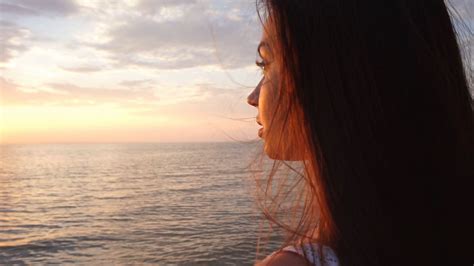 Girl Watching Sunrise On The Beach Silhouette Of Girl Watching Sunrise