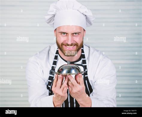 Head Cook Handsome Man In Apron And Cook Hat Chef Cook In Uniform Standing With Delicious Dish
