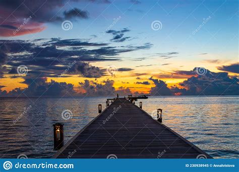 Colorful Sunset Skies Over Pier At The Beach Maldives Stock Image