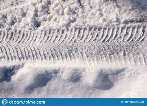 Vehicle And Tractor Tire Tread Imprints On The Snowy Road In Winter