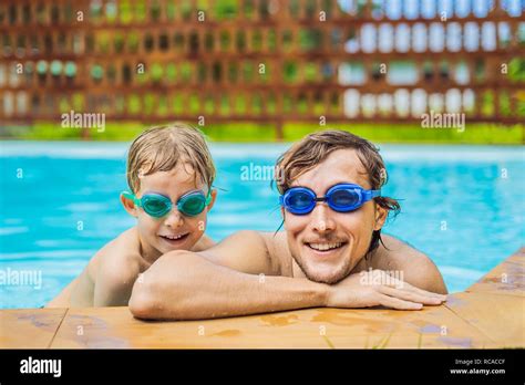 Dad And Son In Swimming Goggles Have Fun In The Pool Stock Photo Alamy