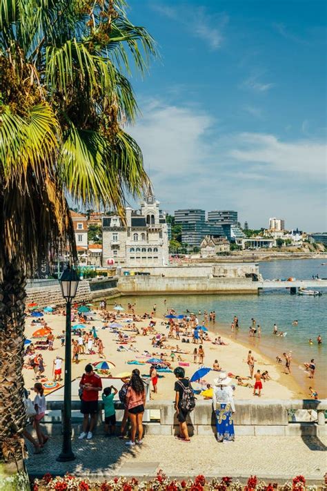 Tourists Having Fun In Water Relaxing And Sunbathing In Cascais Ocean