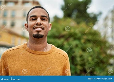 Young African American Man Smiling Happy Standing At The City Stock