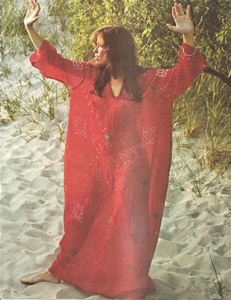 carly simon wearing red caftan standing on the sand photo from circus magazine march 1973