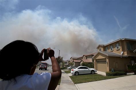Wildfire threatens Rancho Cucamonga homes as residents watch, flee