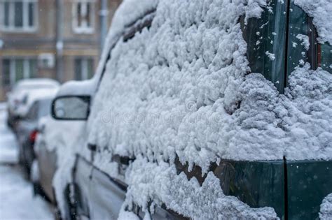 a car in the winter in the parking lot covered with snow in a blizzard stock image image of