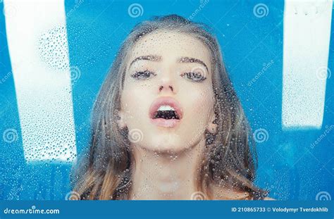 Woman With Water Drops Shower And Hygiene Spa Treatment Drops On Window Glass With Face Of