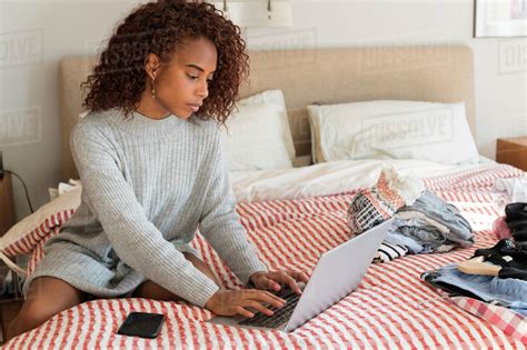 Woman Using Laptop On Bed Stock Photo Dissolve