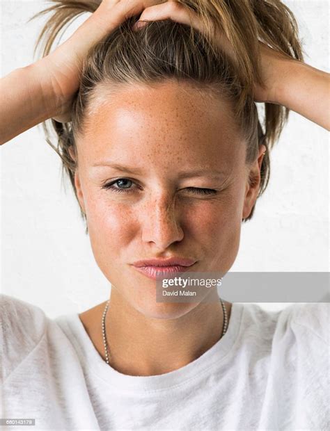 Blonde Woman Holding Her Hair Winking Photo Getty Images