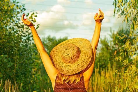 Woman Arms Raised Enjoying The Fresh Air In Green Forest Stock Photo