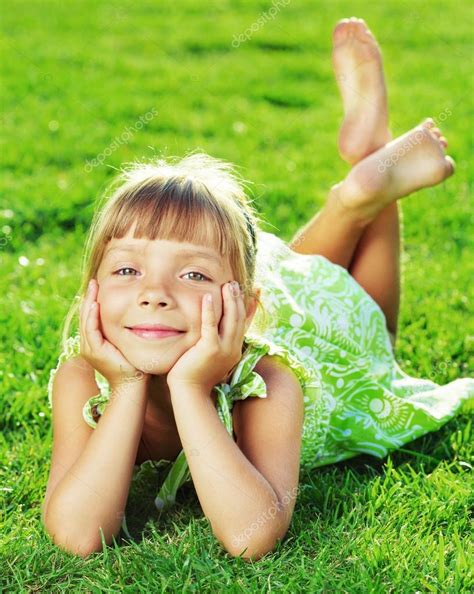 Little Girl Lying On A Green Grass — Stock Photo © Allllex 61544677