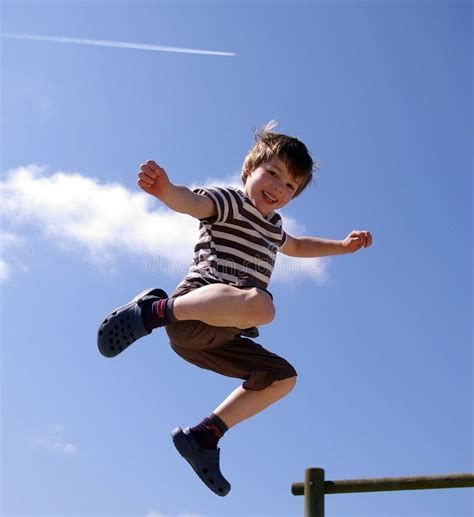 Happy Smiling Kid Jumping Kid Having Fun Jumping In The Air With