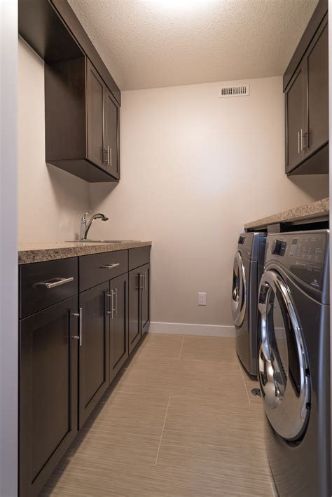 Laundry room with custom cabinets for ultimate storage! | Harmony house