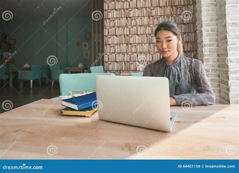 Cute Woman Successful Freelancer Using Laptop Computer While Sitting In