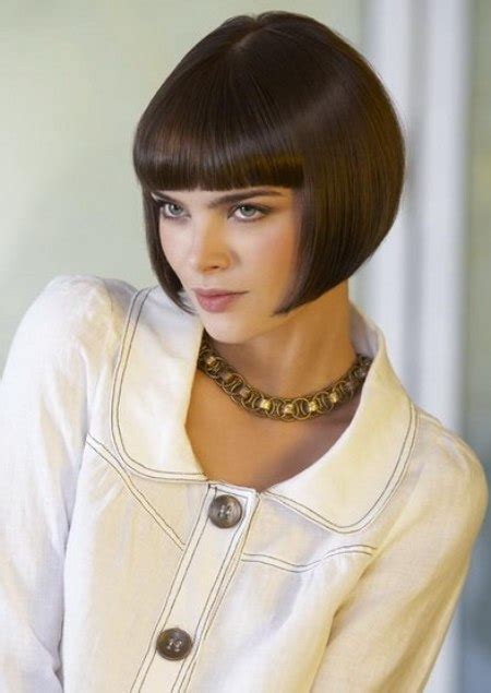 The hair is left about 2.5 inches long on top and can be worn casually swept back with the fingers (as she's wearing it in the photo above) or neatly parted and combed for a formal look. Classic short bob with a shorter neck area