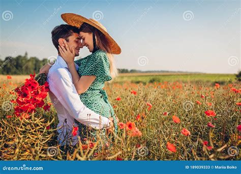 Loving Couple Walking In Poppy Field With Bouquet Of Flowers Happy Man