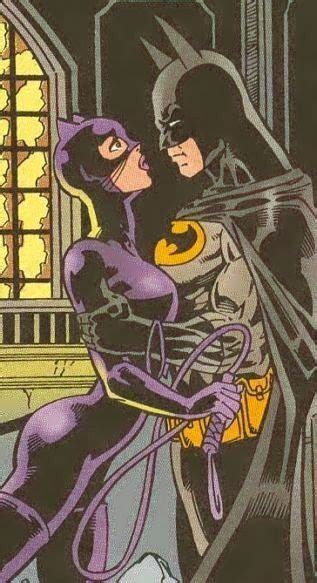 Batman And Catwoman Kissing In Front Of A Window