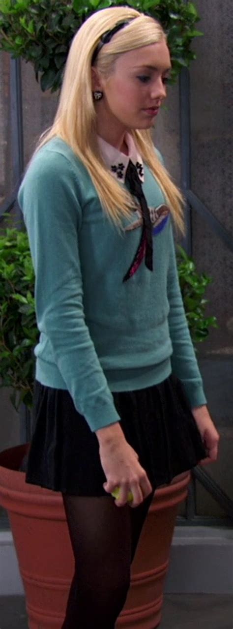 A Woman With Long Blonde Hair Is Standing In Front Of A Potted Plant And Wearing Black Tights