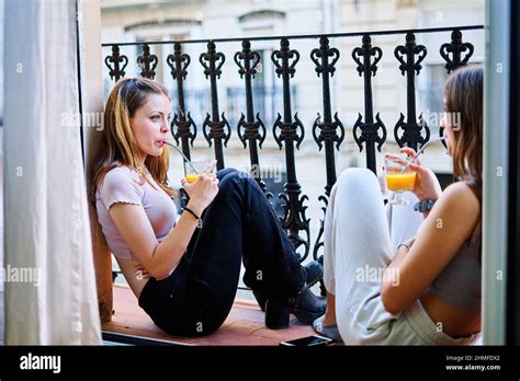 Two Female Friends Drinking At An Outdoor Party Stock Photo Alamy