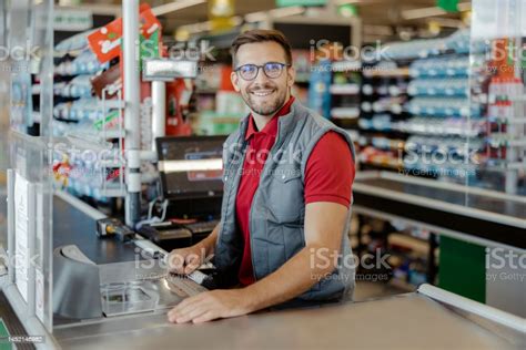 Portrait Of A Smiling Shopkeeper Looking At Camera Stock Photo